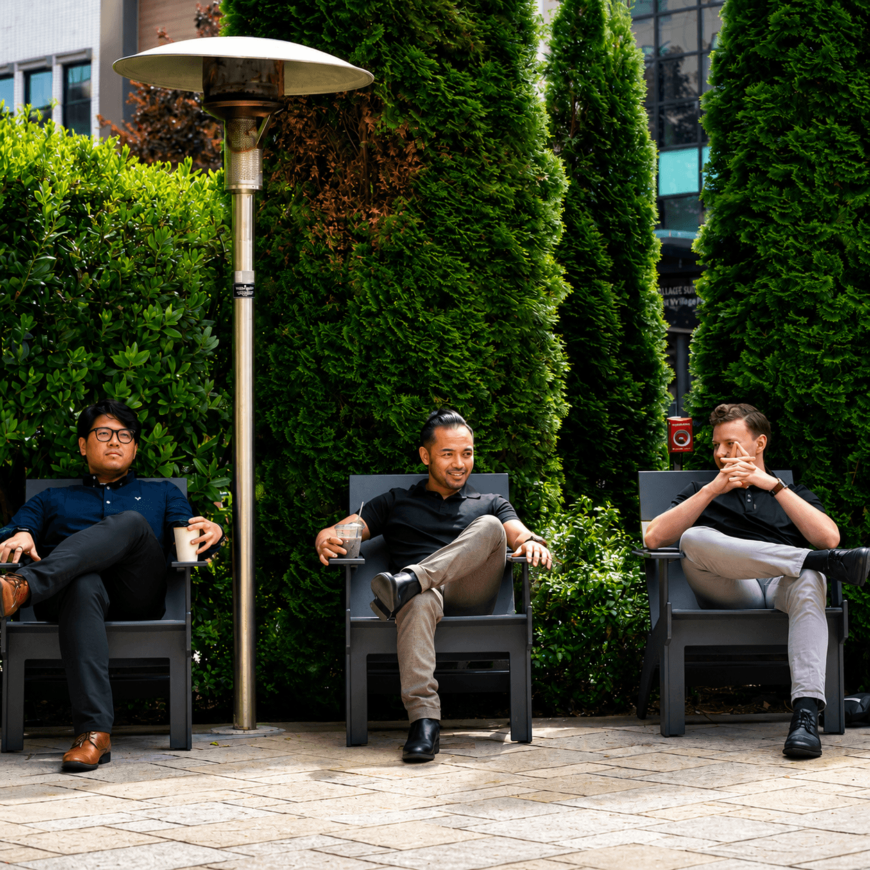 The ScaleYourCo executive team, seated together outside their workspace